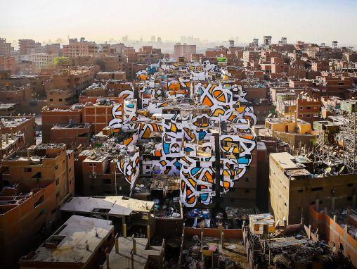 Click to play eL Seed: A project of peace, painted across 50 buildings